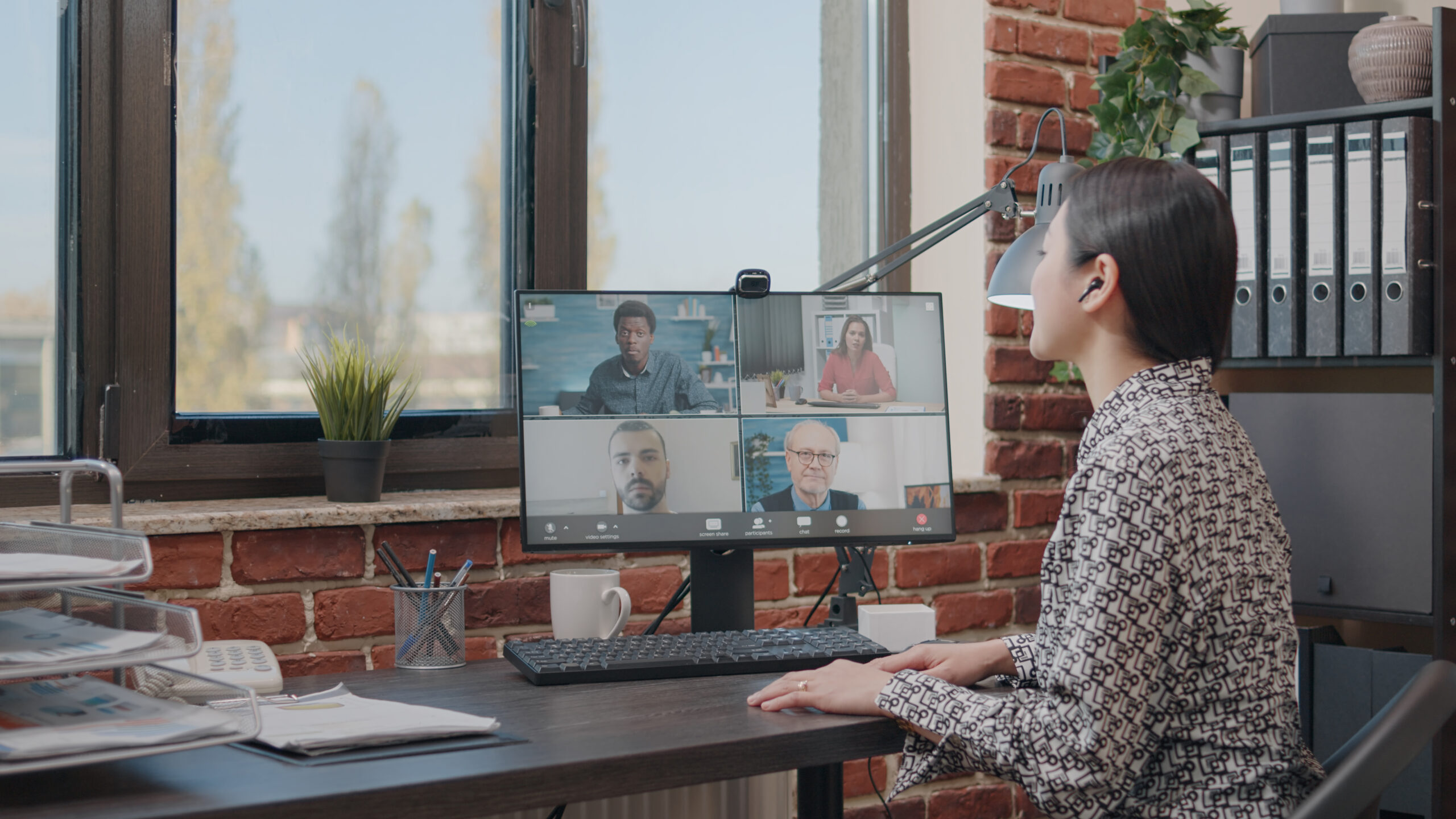 Business woman talking to colleagues on online video call remote leadership sales