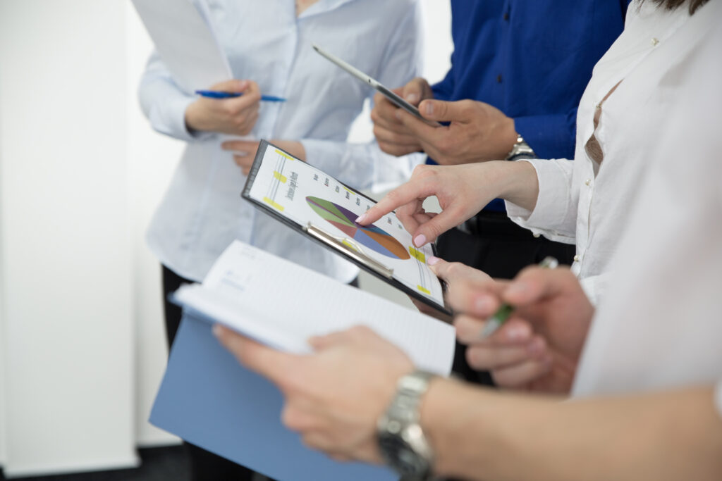 crop-people-watching-graphics-statistics sales outsourcing partner