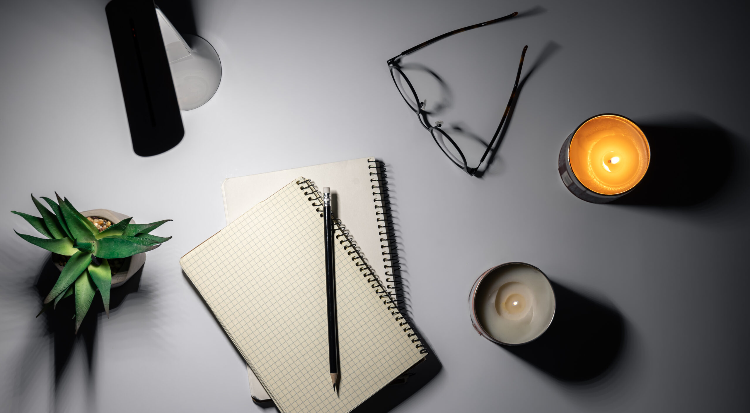 Flat lay, notepad and lamp, night workspace at home, deadline.