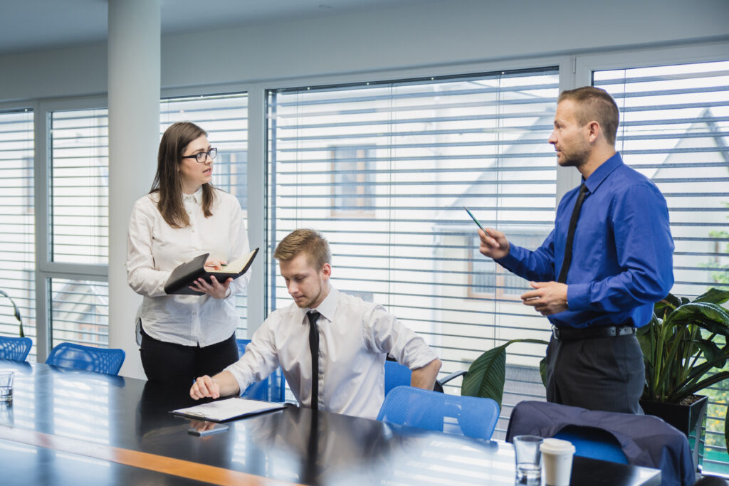 man-talking-coworkers-office scaling your business