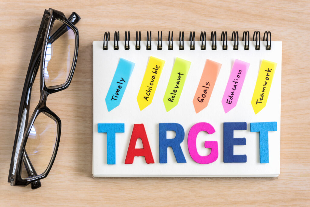 Wood letter of target word with hand writing definition, sales follow-up